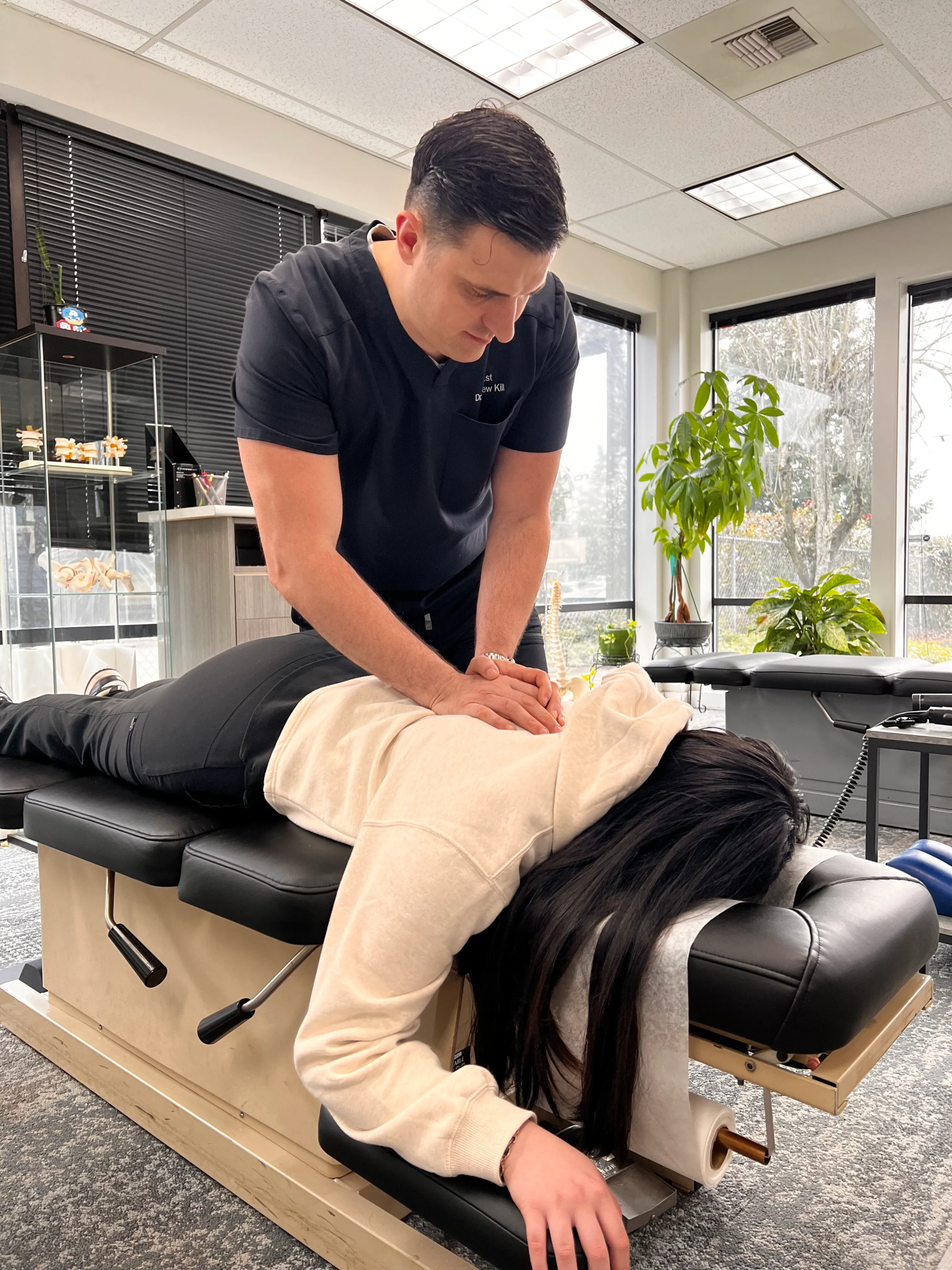 Chiropractor adjusting a patient at Chiro 1st