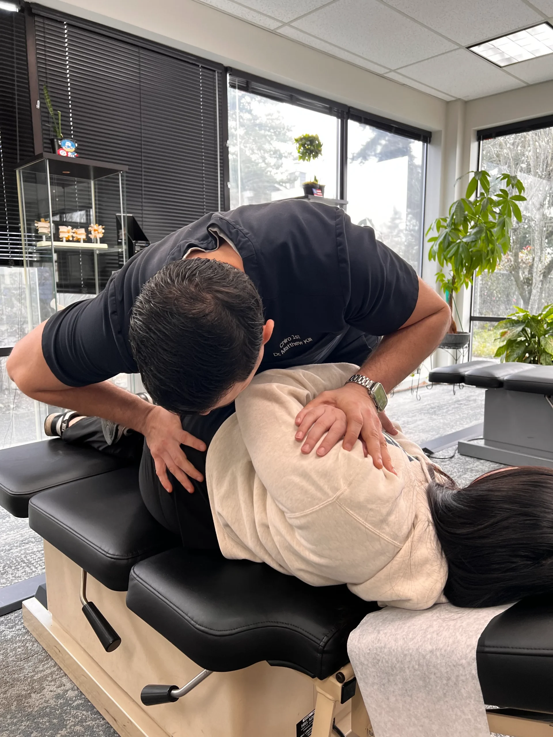 Chiropractor treating a back pain patient at Chiro 1st