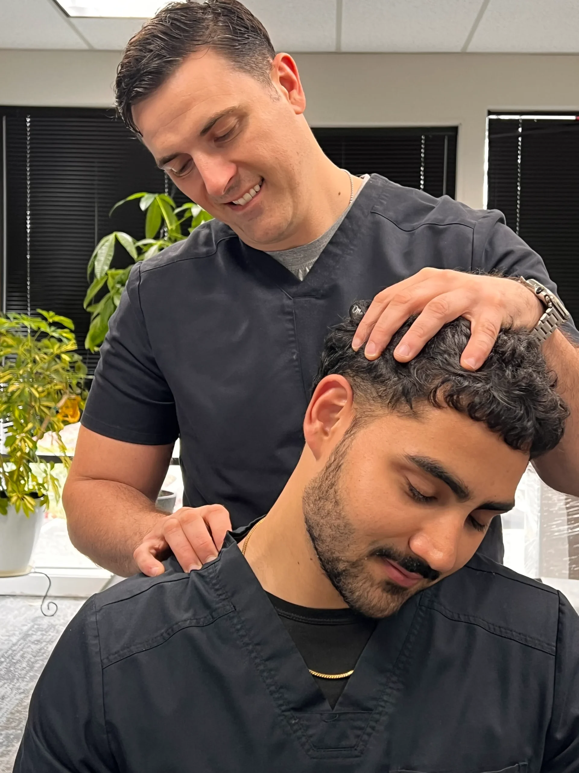 Chiropractor assessing a patient's neck at Chiro 1st