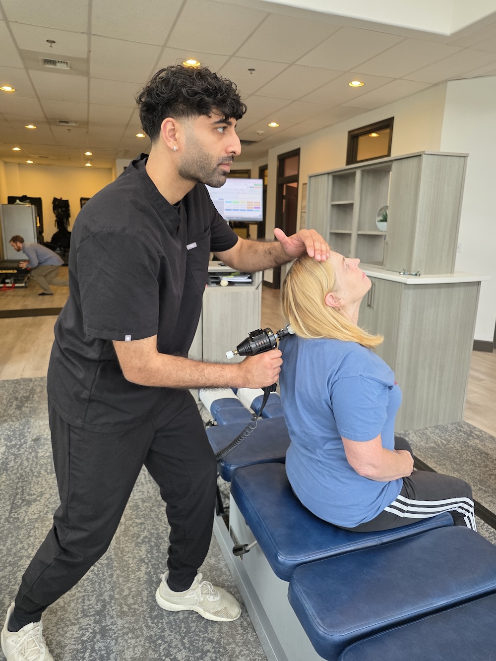 Chiropractor adjusting a patient's neck at Chiro 1st